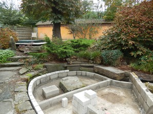 A smaller area will be filled with stone and wet loving plants