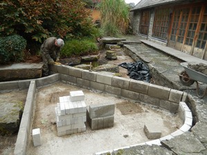 Concrete blocks being laid in the new shaped pond