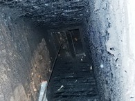 View up the inside of the chimney, showing the baffle plate